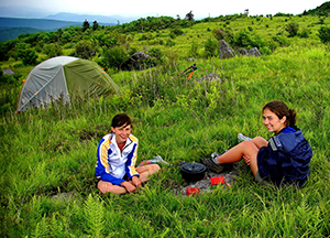 Kids camping in a meadow