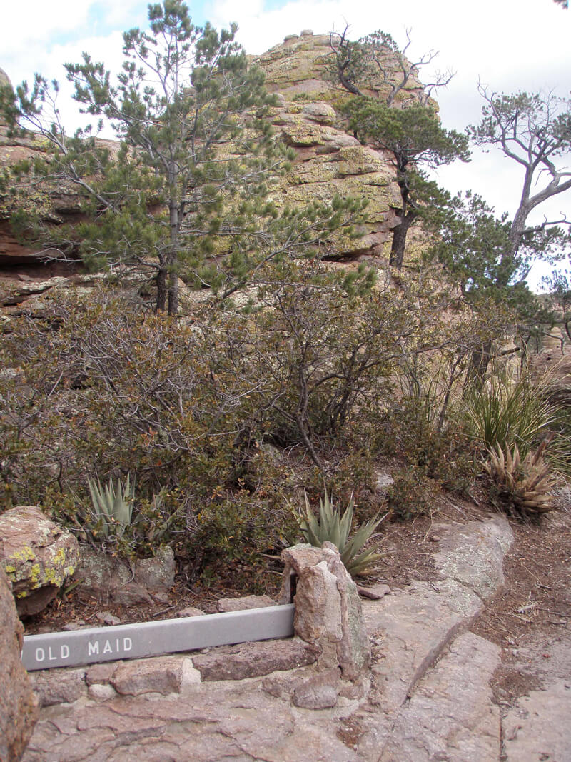 A sign marking a made up feature by a rock outcropping