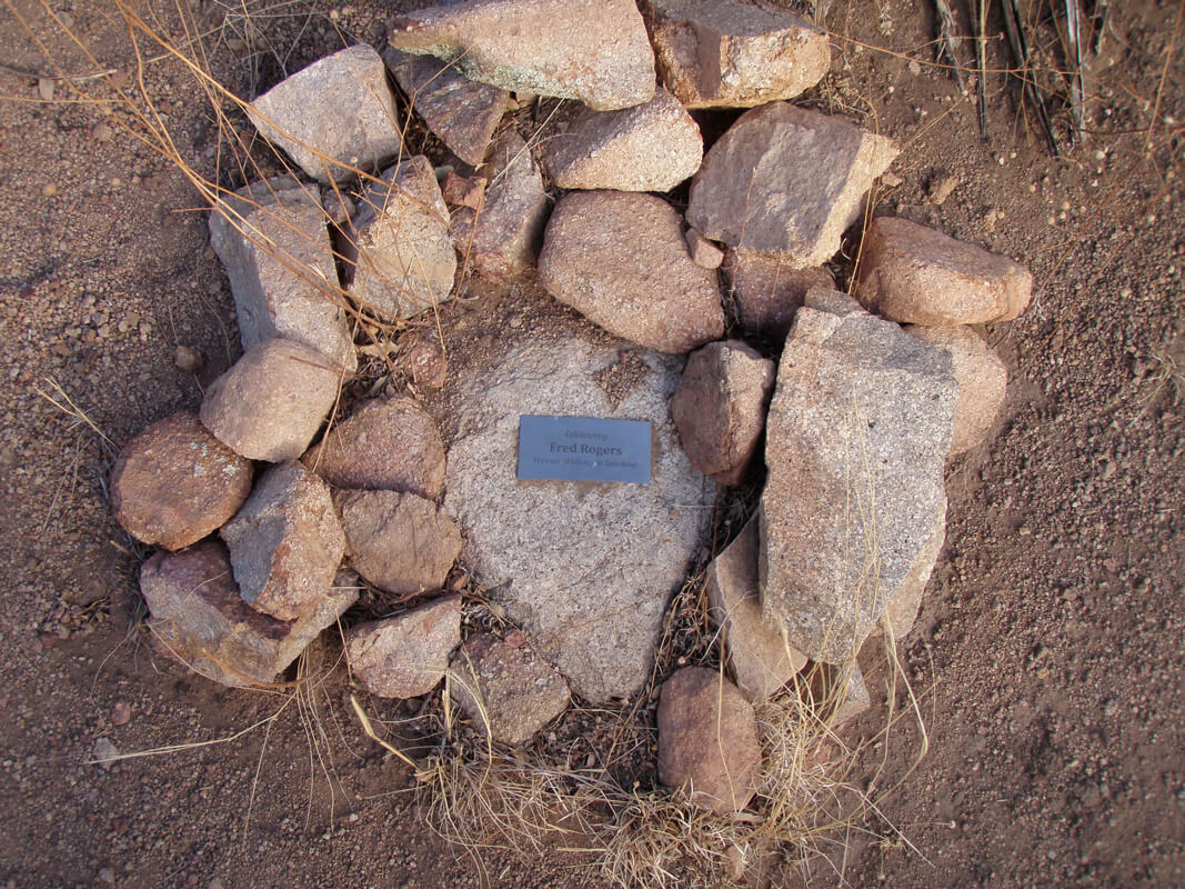 A rock memorial with a metal plaque