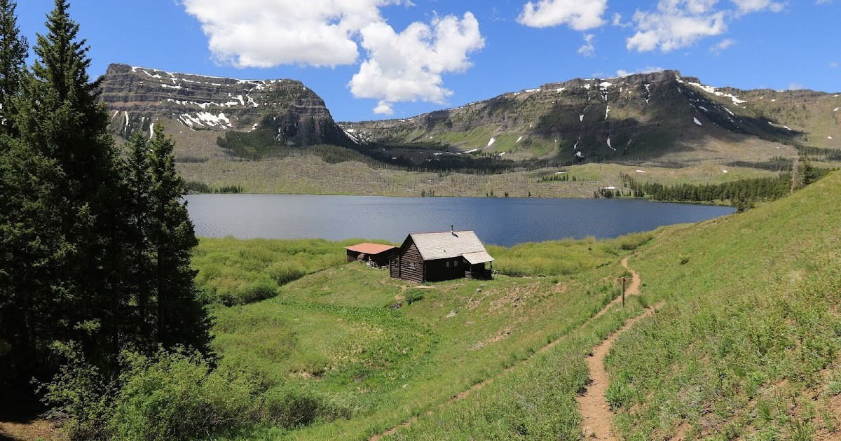 Remote cabin near a lake with mountains in the background